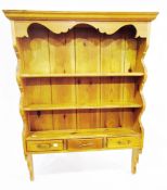 Pine open shelf plate-rack with three frieze drawers,