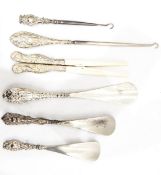 A collection of silver-handled shoe horns, button hooks, glove stretchers, etc.