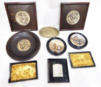 Quantity of oak-mounted silver-coloured relief moulded plaques, potlids, etc.