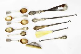 Two button hooks with silver handles, one decorated with a cherub's head,