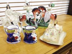 Pair of Staffordshire figures of a gentleman and his lady seated on chestnut horses,