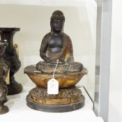 Late 18th/early 19th century lacquered carved wooden model of a seated Buddha with gilt highlights,