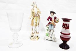 Sitzendorf porcelain figure of a gentleman holding bird and basket of flowers,