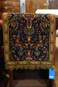 Small fringed rug with stylised floral pattern within a yellow ground border