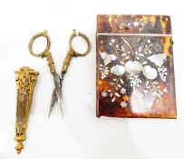 Tortoiseshell and mother-of-pearl card case and a pair of gold-coloured metal scissors in leather