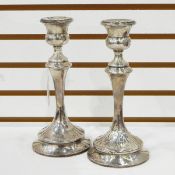 Pair of George V silver table candlesticks, each with thistle-pattern sconce,