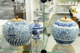 Two Chinese blue and white ginger jars, with wooden pots, 23cm and 20cm high,