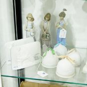 Three Lladro figures of girls holding flowers etc.