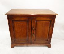 Dwarf late 19th century oak cupboard enclosed by two field panelled doors, on plinth base,