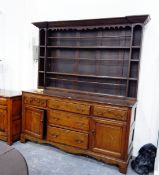 Georgian style oak dresser, the open shelf plate rack with carved frieze,