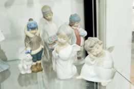Lladro figure of a praying cherub with another, two winter figures, a snowball and a bear,