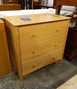 Contemporary pale beech chest of three long drawers, with elegant turned wooden handles,