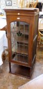 Arts & Crafts style oak corner display cabinet having four shelves enclosed by leaded and stained