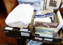 Various tablecloths and embroidered table linen including a large white tablecloth,