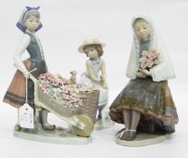 Lladro models of a Spanish dressed girl holding flowers,