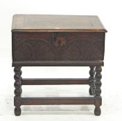Oak bible box with carved front, on turned stand, 60cm diameter and an oak spinning chair,