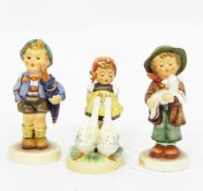 Three various Goebel Hummel figures including boy with pig in basket on his back,