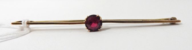 Gold-coloured bar brooch set with a single red circular garnet-topped paste doublet,