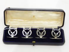 Set of four silver menu card holders, maker's mark G&CH, Birmingham 1913/14,