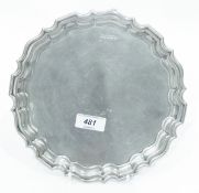 Silver salver by Walker & Hall, Sheffield 1919, of shaped circular form, on three scroll feet,