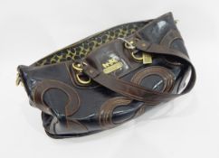 Coach black and brown leather handbag decorated with the Coach emblem, with brass fittings,