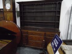 Georgian oak dresser, the open shelf plate rack with carved frieze,