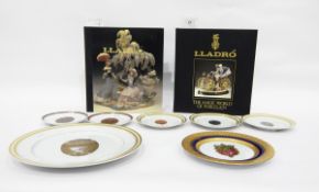 Quantity of collector's china plates depicting Faberge eggs and two hardback copies of Lladro 