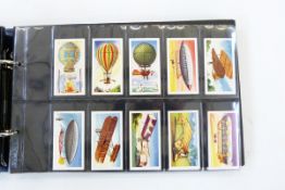 Three albums and contents of cigarette cards including Mills Histoire de L'Aviation, Lambert &