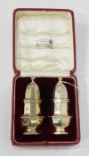 Pair of early 20th century silver pepperettes, London 1926, maker's mark worn, 10.