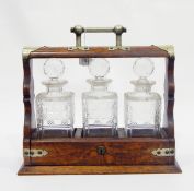 Early 20th century oak tantalus with metal mounts and locking mechanism,