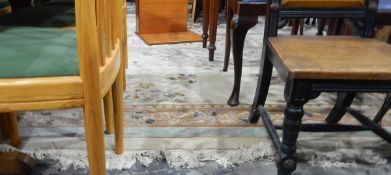 Chinese wool rug, the cream ground floral decorated with brown and green striped border,