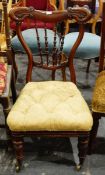 Late Victorian mahogany-framed nursing chair with turned spindle back, carved and shaped crest rail,