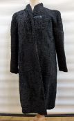 Black astrakhan coat with the label 'Browns of Chester' and a patterned satin lining