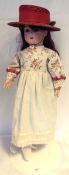 German bisque headed doll marked 'Thuringia', with fixed blue eyes and open mouth,