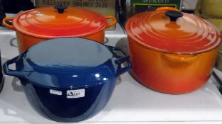Two large orange Le Creuset casserole dishes and a blue enamel casserole dish marked 'Denmark'