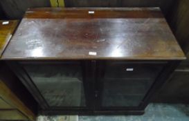 Old mahogany glazed bookcase, the pair of panelled doors enclosing shelf, raised on a plinth,