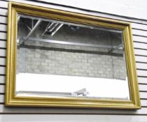 Rectangular wall mirror with bevelled plate, in a moulded gilt frame,