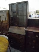 Mid 20th century oak bureau/bookcase, the astragal-glazed top enclosing adjustable shelves,