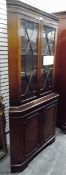 Georgian-style mahogany corner cupboard with dentil cornice,