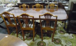 Reproduction mahogany extending dining table united by stretcher, on cabriole legs,