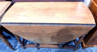 Old oak oval-top gateleg table with moulded edge, on turned baluster supports,