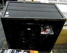 Sony music centre within a black glass and wooden shelf unit