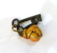 Carved stained ivory fist holding a ball