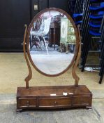 Reproduction mahogany oval toilet mirror of three drawers, on bracket feet,