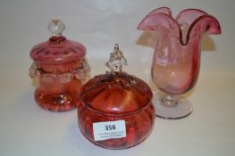 Two Cranberry Glass Lidded Bowls and a Cranberry Glass Vase
