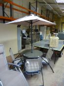 Circular Patio Table with Four Folding Chairs and an Umbrella