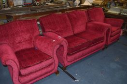 Red Upholstered Three Piece Suite Consisting of a Two Seat Sofa and Two Armchairs