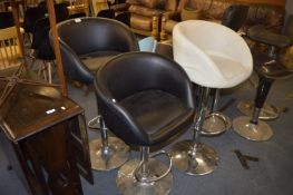 Pair of Black and One White Gas Lift Barstools