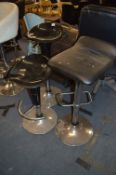 Pair of Black Plastic Gas Lift Barstools and One Black Leather Seated Barstool