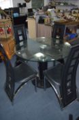 Circular Glass Topped Dining Table with Four Leatherette and Chrome Dining Chairs